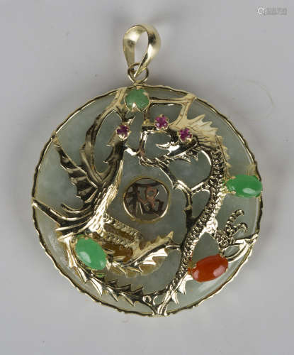 A 14ct gold mounted circular jade pendant, the front with a gem set Oriental dragon motif, length