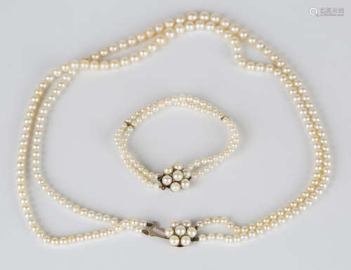 A two row necklace of graduated cultured pearls on a 9ct gold, cultured pearl and diamond clasp,