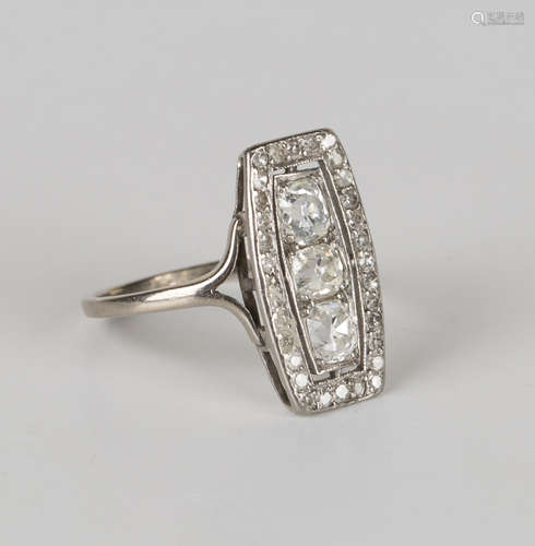 A white gold and diamond panel shaped cluster ring, mounted with the three principal cushion cut