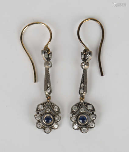 A pair of silver, diamond and sapphire pendant earrings, the terminals designed as floral