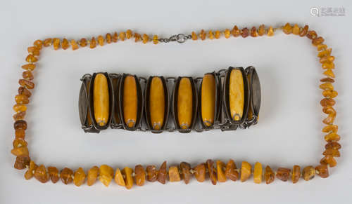 A silver and amber bracelet, formed as a series of wide tapered links, each curved link mounted with