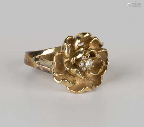 A gold and diamond cluster ring in an abstract floral design between split shoulders, detailed '