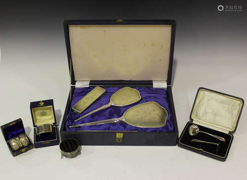 A small group of silver items, including an Elizabeth II four-piece dressing table set with reeded