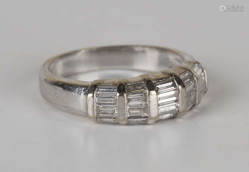 A white gold and diamond ring, mounted with five rows of four graduated baguette cut diamonds,