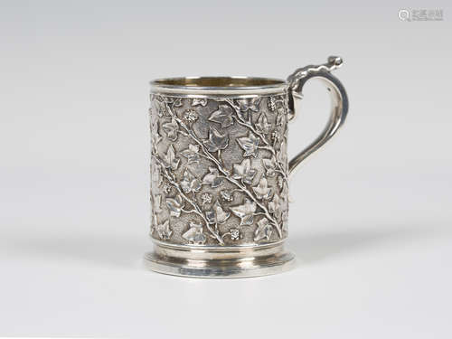 A George IV silver christening mug, the cylindrical body decorated with fruiting vines, flanked by a