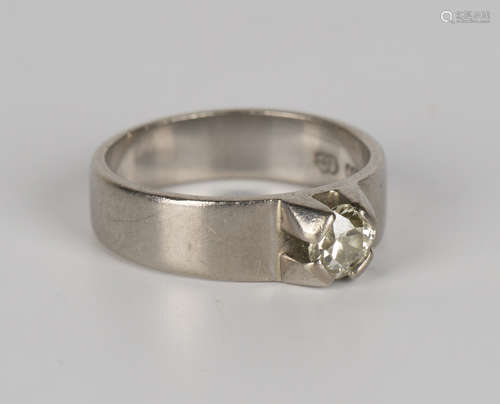 A white gold and diamond single stone ring, mounted with a cushion cut diamond, detailed '750', ring