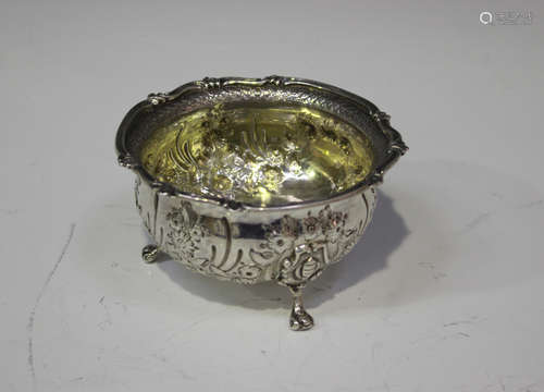 A George II silver circular bowl with cast scroll rim, the body later chased with flowers and