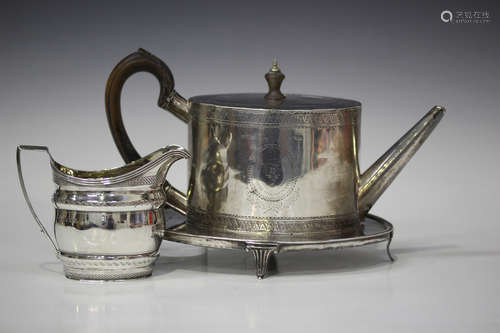 A George III silver oval teapot, engraved with a crest in a circular pendant cartouche between