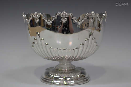 A late Victorian silver monteith of half-reeded form beneath a scallop and scroll rim, London 1896