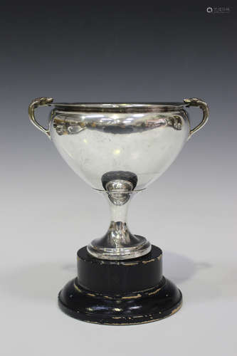 A George V silver trophy cup, the ovoid body flanked by two scroll handles with dog head