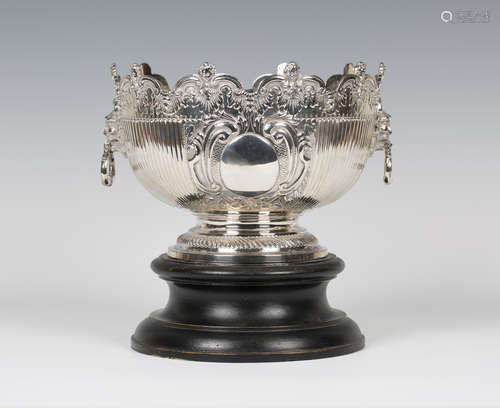 A late Victorian Queen Anne style Britannia silver monteith, the half-fluted circular bowl with