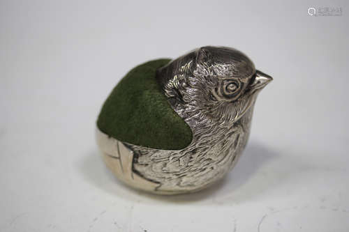 A George V silver novelty pin cushion in the form of a chick emerging from an egg, London 1923 by