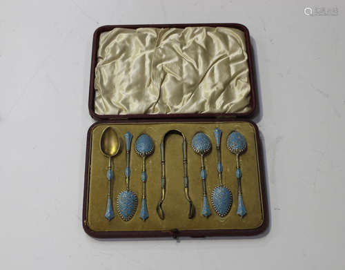 A set of six early 20th century Norwegian silver gilt and enamelled coffee spoons with matching