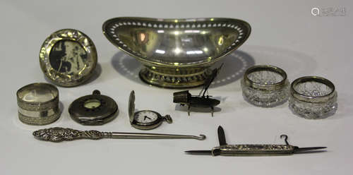 A late Victorian silver oval bonbon dish with pierced rim, raised on a similarly decorated oval