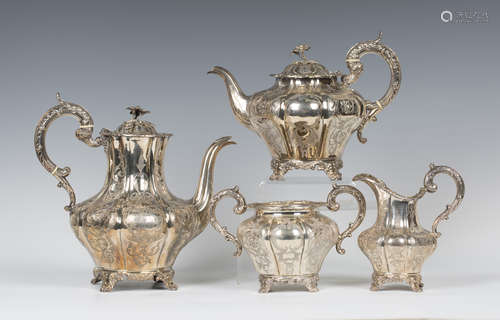 A Victorian silver three-piece tea set of lobed baluster form with floral finials above engraved