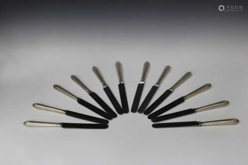 A set of twelve Victorian silver handled Old English bead pattern table knives, the steel blades