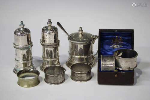 A Queen Anne style silver three-piece condiment set, comprising a pair of lighthouse salt and pepper