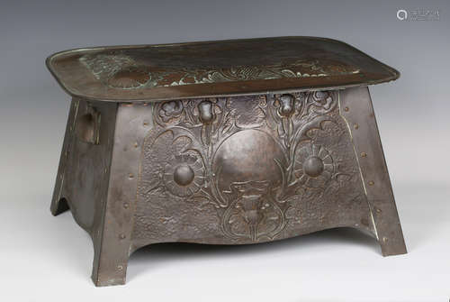 An early 20th century Arts and Crafts copper log bin, the hinged lid and front worked with