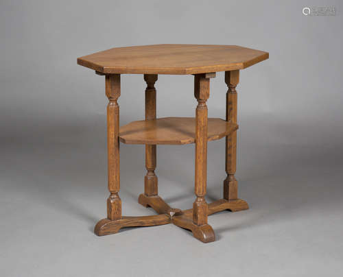 An early/mid-20th century Arts and Crafts oak octagonal two-tier occasional table, in the manner