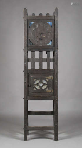 An early 20th century American Arts and Crafts stained oak longcase clock by Sessions Clock Co, with