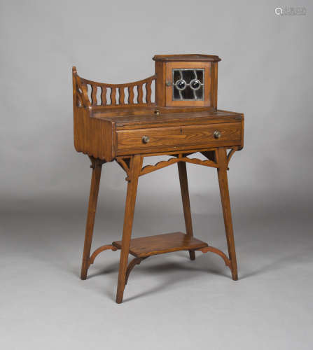 An Edwardian Arts and Crafts stained ash writing table, in the manner of Liberty & Co, the gallery