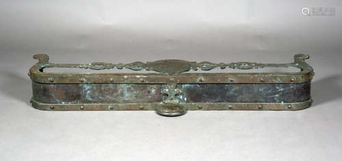 A late 19th century patinated bronze fender of shaped form and riveted construction, height 16cm,