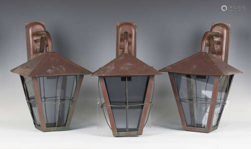 A set of three mid-20th century Arts and Crafts style patinated copper wall lanterns, the