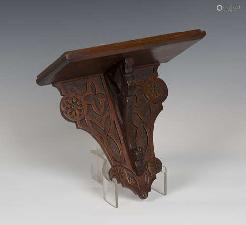 A late Victorian Aesthetic Movement oak wall bracket, the pierced support and shaped backplate