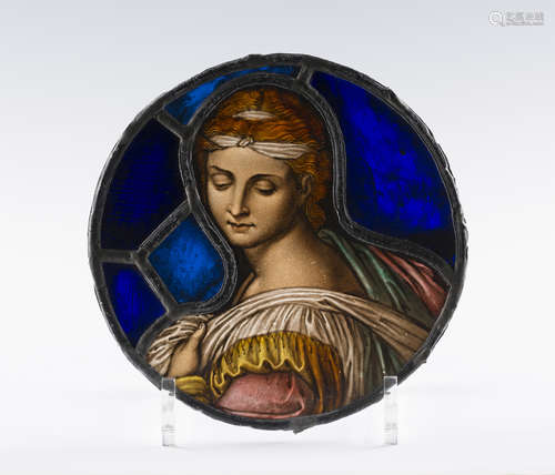 A Renaissance style stained and leaded glass circular portrait panel, depicting the head and