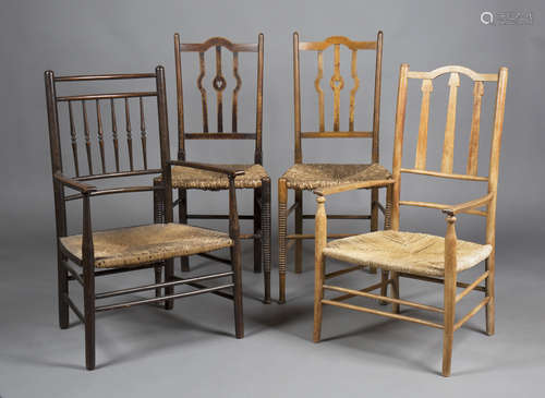 An Edwardian Arts and Crafts stained beech Sussex armchair with a spindle back and rush seat, height