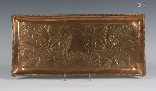 An Edwardian Arts and Crafts copper rectangular tray, dated '1907' and worked with stylized plant