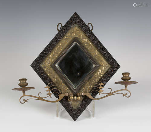 A late Victorian Arts and Crafts brass and oak framed two-light girandole wall mirror, the