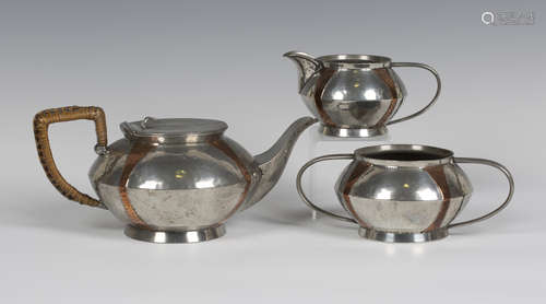 A late Victorian Arts and Crafts 'English Pewter' three-piece tea set, each squat circular body with