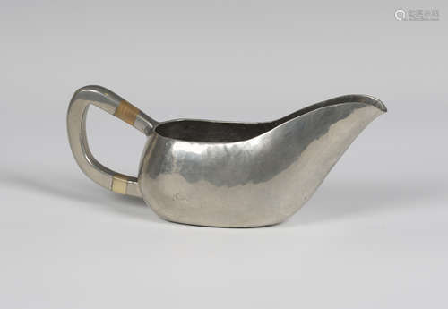 An early 20th century German Urach hammered pewter gravy boat, designed by the Bauhaus student