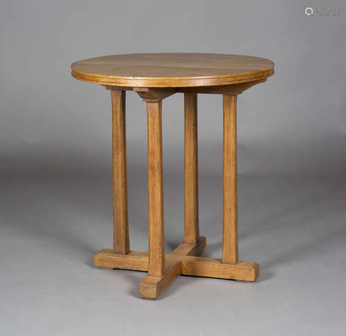 An early/mid-20th century Arts and Crafts style oak circular occasional table, in the manner of