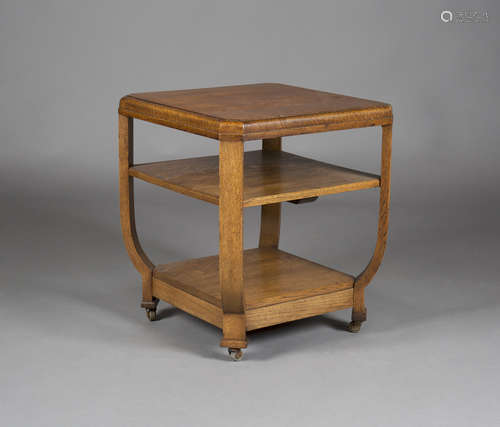 An early 20th century oak three-tier occasional table, in the manner of Heals, the canted square top