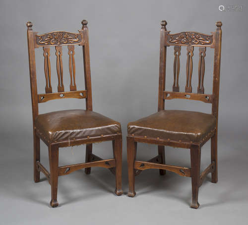 A pair of Edwardian Arts and Crafts walnut framed side chairs, the carved bar and pierced splat