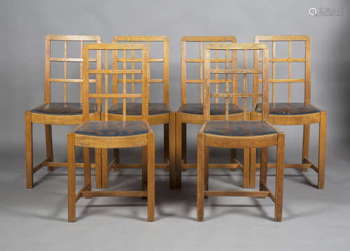 A set of six early 20th century Arts and Crafts oak lattice back dining chairs, probably by Heals,