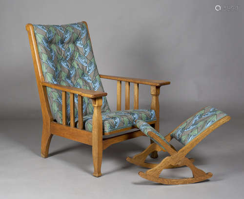 An Edwardian Arts and Crafts oak framed reclining armchair by James Shoolbred & Co, the buttoned