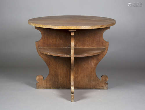 A late 20th century Arts and Crafts style oak two-tier circular centre table, retailed by James