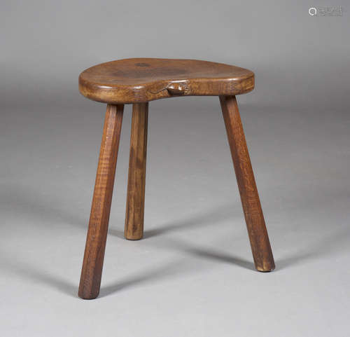 A Robert 'Mouseman' Thompson oak stool, the kidney-shaped seat panel with typical carved mouse