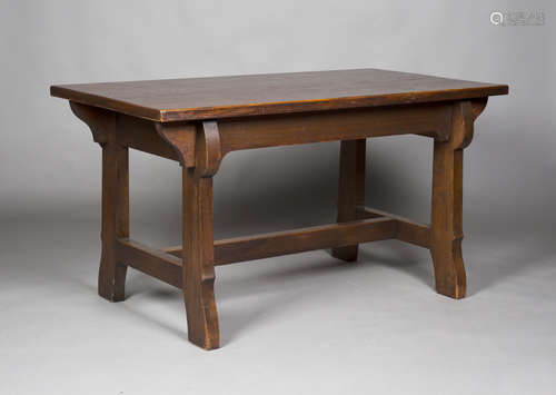 An early 20th century Arts and Crafts stained oak rectangular centre table, raised on shaped