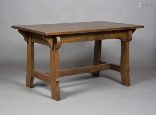 An early 20th century Arts and Crafts stained oak rectangular centre table, raised on shaped