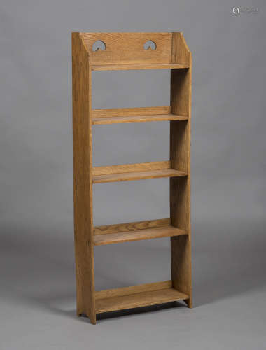 An Edwardian Arts and Crafts oak five-tier open bookcase, the gallery back pierced with two inverted