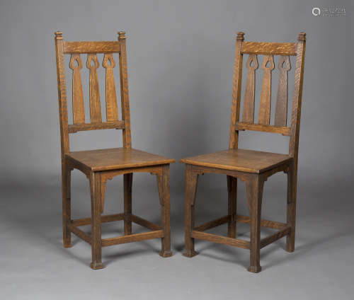 A pair of Edwardian Arts and Crafts oak side chairs by Shapland & Petter of Barnstaple, the triple