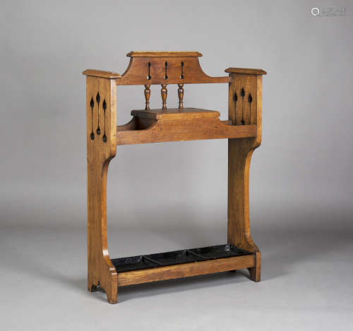 An Edwardian Arts and Crafts oak hallstand, in the manner of Liberty & Co, the back and sides with
