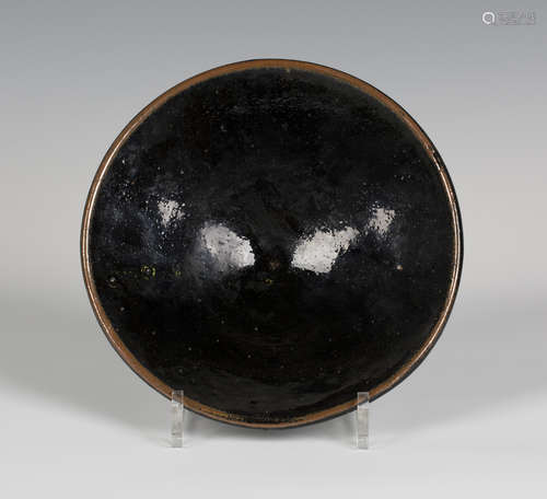 A tenmoku glazed studio pottery bowl, probably by Richard Batterham, of flared circular shape on a