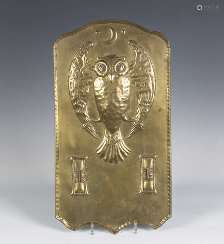 A late 19th/early 20th century Arts and Crafts brass wall sconce backplate, the shaped panel