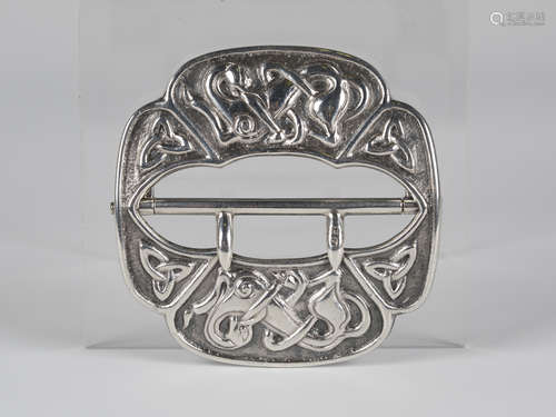 An Edwardian Arts and Crafts 'Iona' silver buckle of shaped form, worked with Celtic knots and