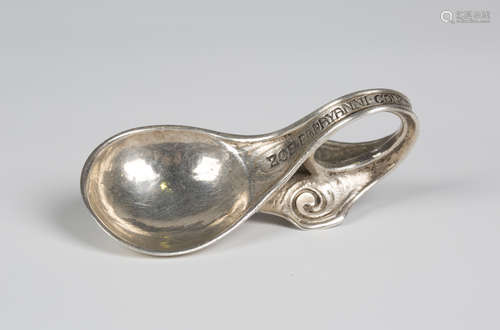 A George V Arts and Crafts silver caddy spoon, the hammered bowl issuing a loop handle, inscribed '